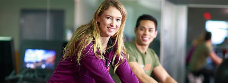 Ashleigh McIvor and Man on stationary bikes