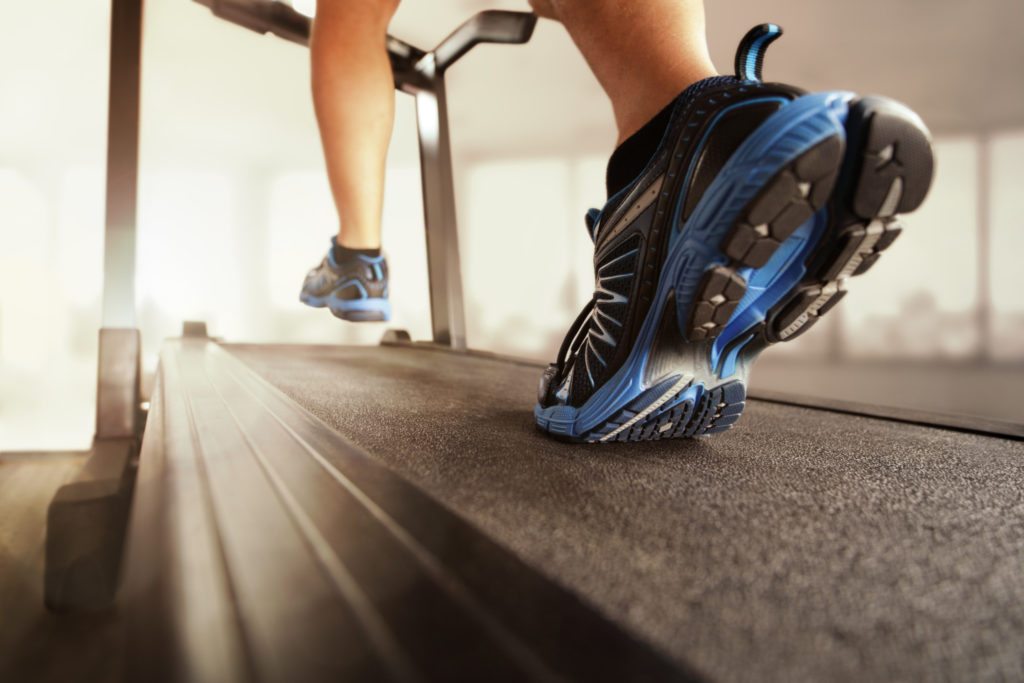 Running on treadmill Man running in a gym on a treadmill concept for exercising, fitness and healthy lifestyle