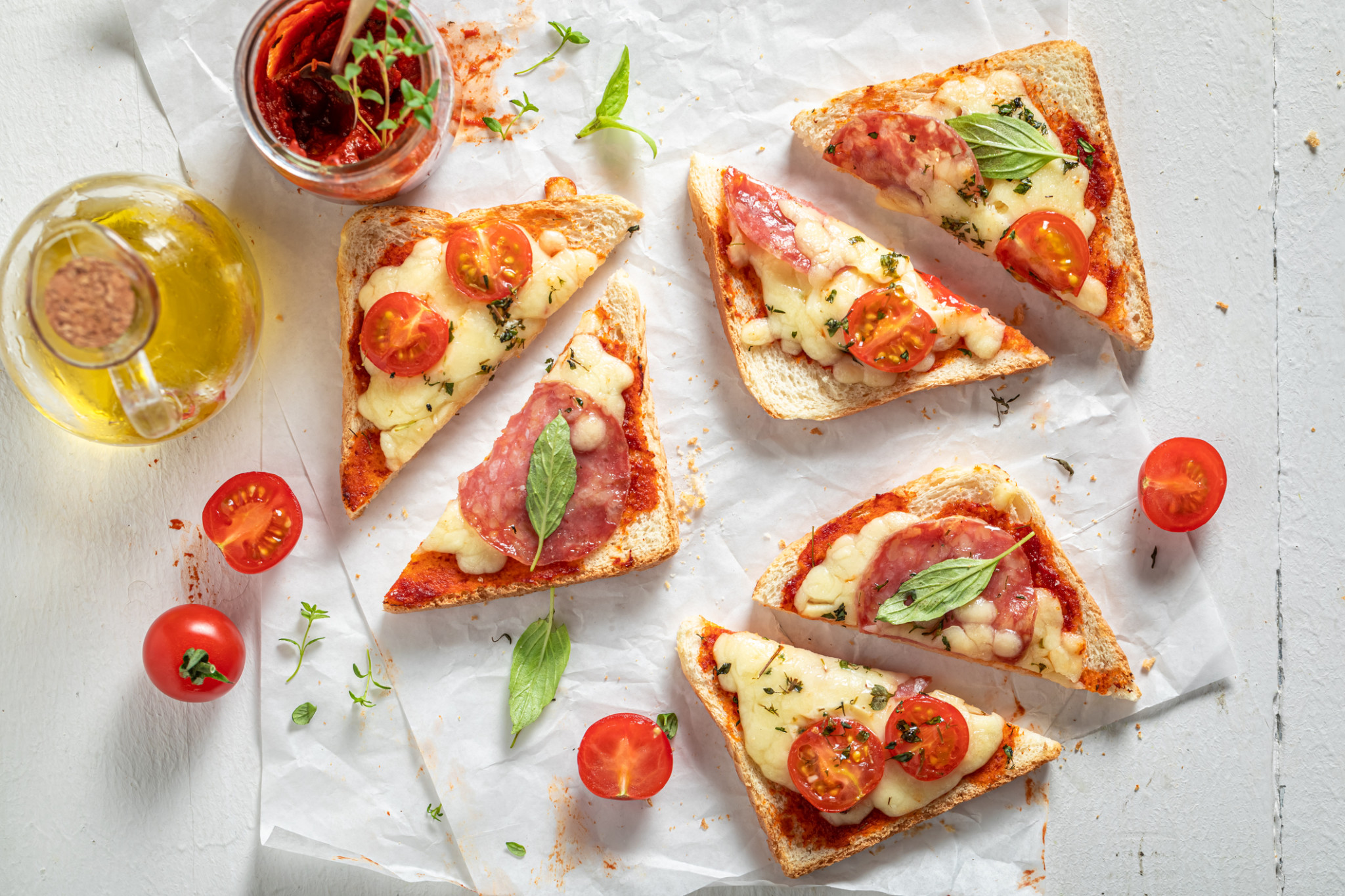 Toast with cheese, salami and basil